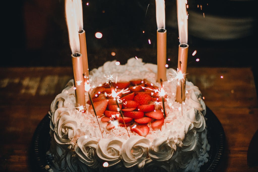 Lighted Candles on an Elegant birthday Cake